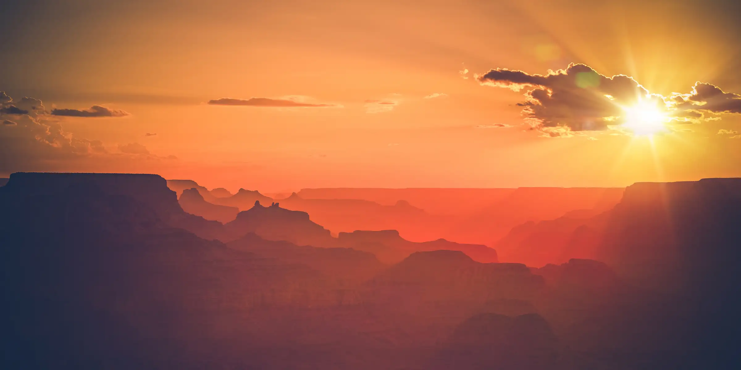 Sunset over the Grand Canyon, Arizona — layered canyon ridges in warm evening light